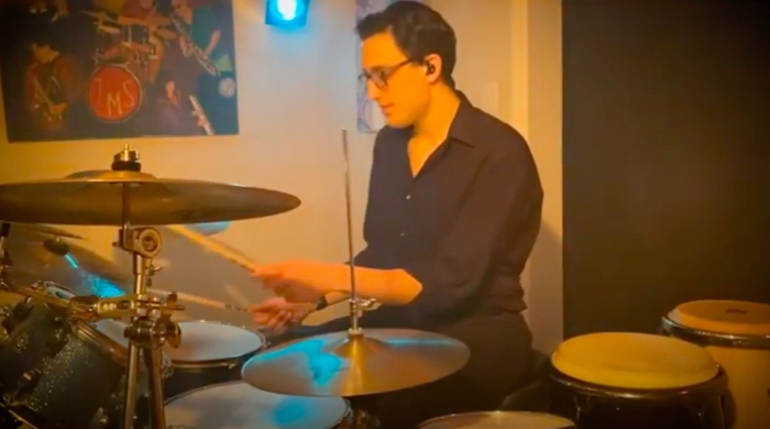 Screenshot from Jared Shaw's senior recital video of Jared playing the drum set.