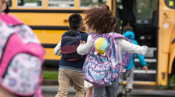 child runs for bus