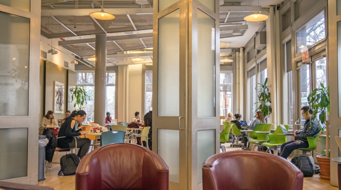 Students lounge and study in the first floor lounge at Pless Hall