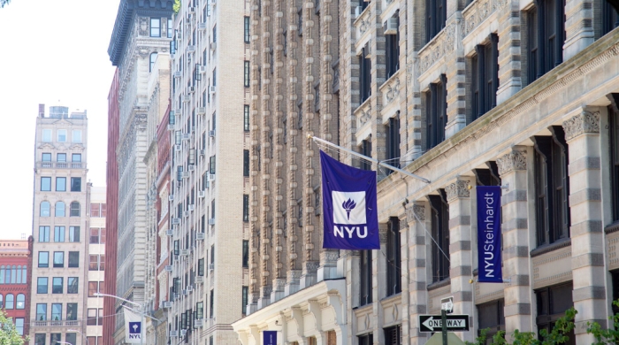 NYU and NYU Steinhardt banners hanging outside campus building