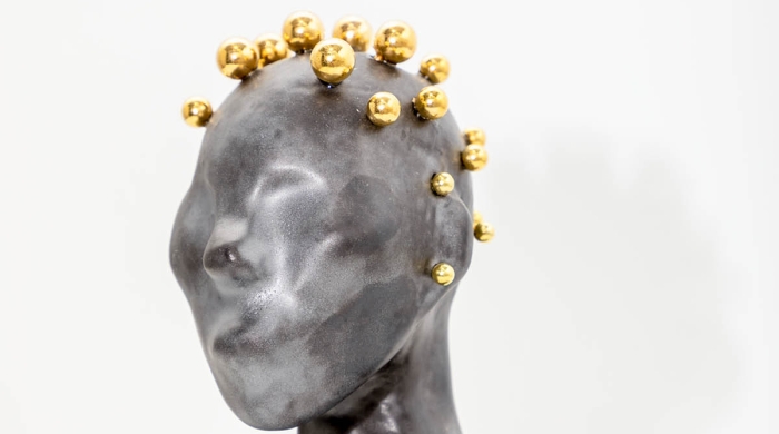 Black ceramic bust with gold hair.