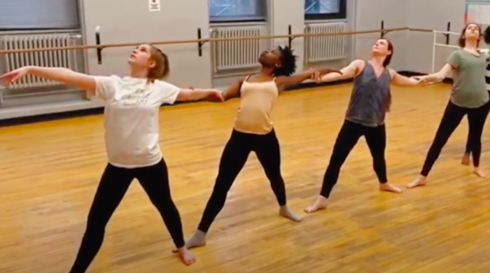 Four dancers rehearsing in a studio