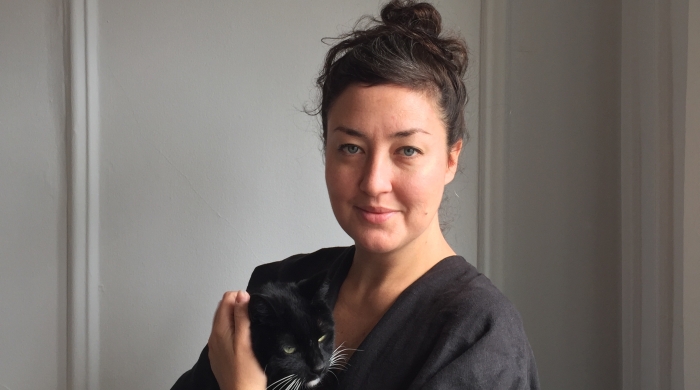 Hi'ilei Hobart holding a cat.