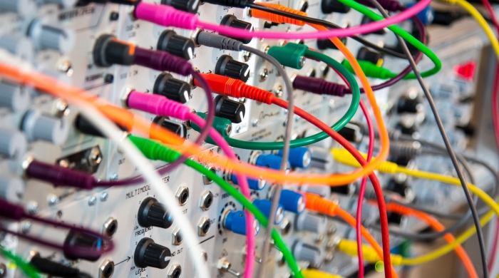 A picture of multicolored wires plugged into a switch board