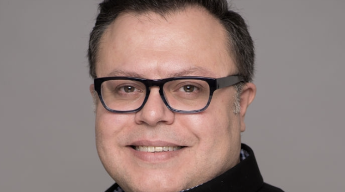 man with glasses smiling