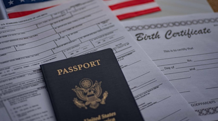 passport, a birth certificate, an American flag, and a citizenship form