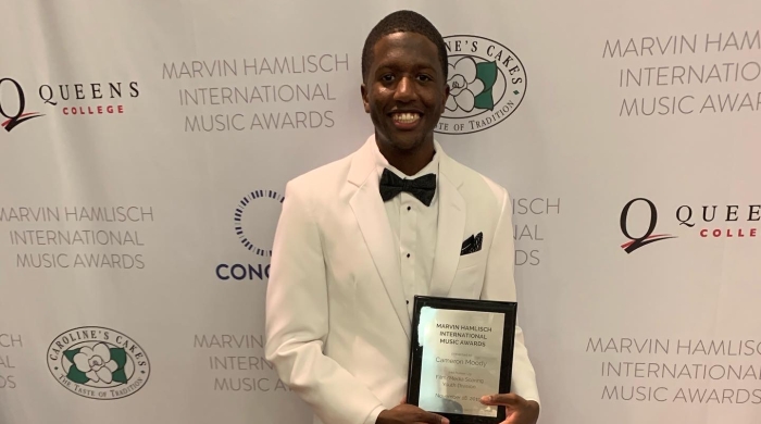 man holding award