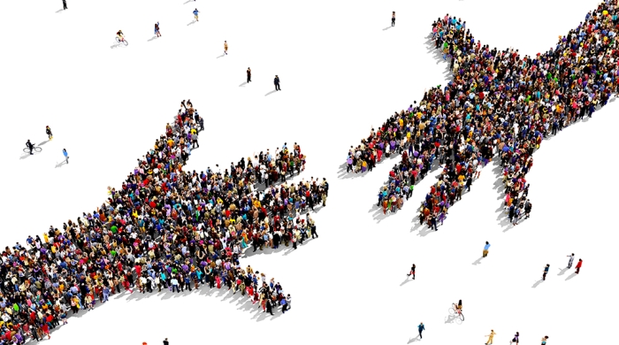 illustration of two hands trying to touch made up of people