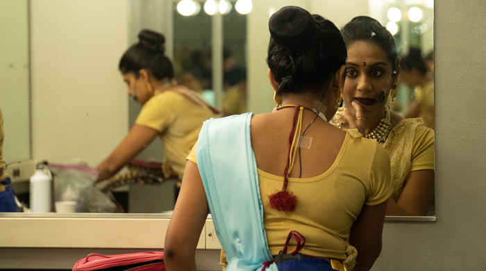 woman looking in mirror in dressing room