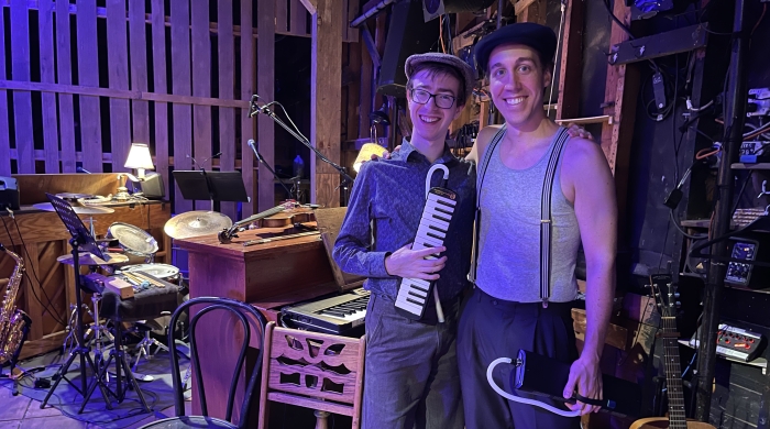 two men backstage with instruments 