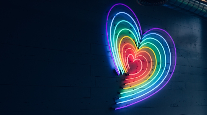 A heart shaped LED light made up of rainbow colors