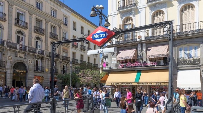 Midday photo of people leaving and entering Sol station in Madrid, Spain.