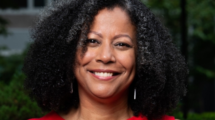 Portrait of Fabienne Doucet in a red shirt with a v-neck color
