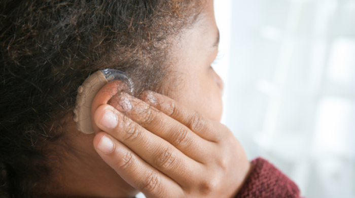 Closeup of black girl with hearing aid