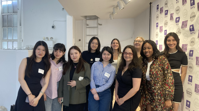 Left to right: Chunchun, Ash, Tian, Jessica, Yu (Sharon), Alicia, Jennifer, Rebecca, and Cindy stand on the stage in the Barney Building Commons