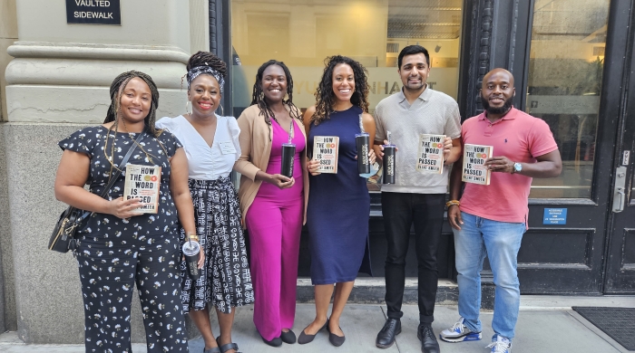 5 faculty first look scholars and Maria Williamson Ramirez standing in front of Pless Hall, holding books