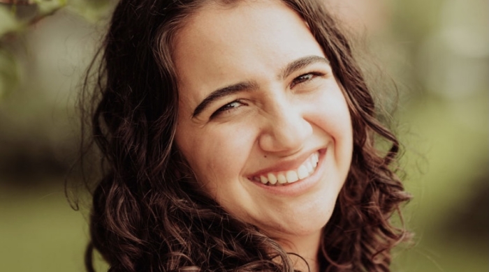 woman with curly hair smiling
