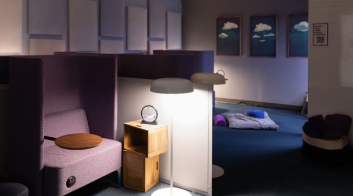 A new study room has dimmed lights, floor seating and highacked chairs.