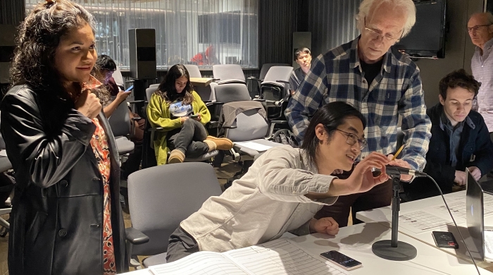 Group of students and a professor working in the screen scoring studio