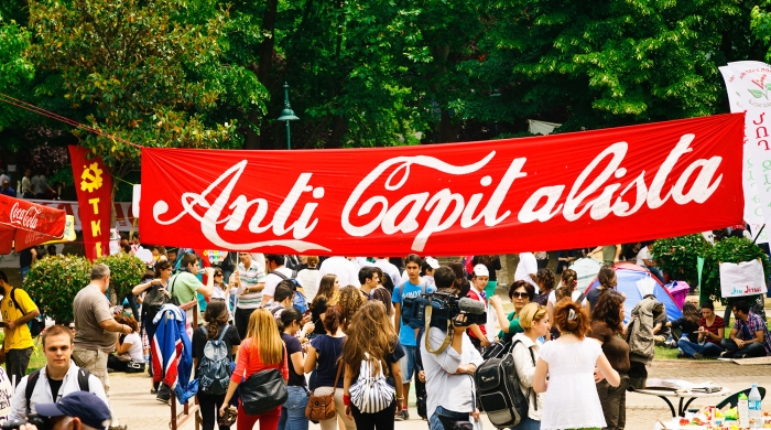 A banner reading "Anti Capitalista" is shown in the same color and fonts used in the Coca Cola branding