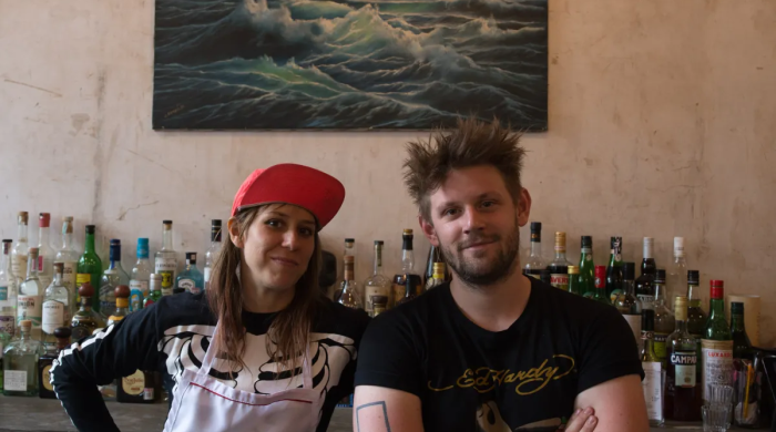 Scarlett Lindeman and Jake Lindeman in front of a bar