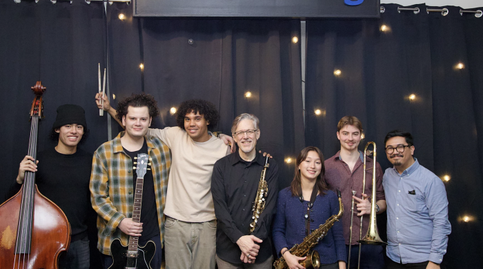 Students from Jazz Studies stand in front of WBGO radio sign