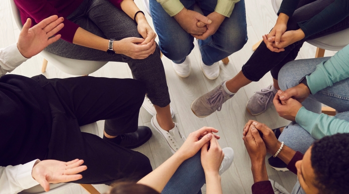 Group of people sitting in a circle.