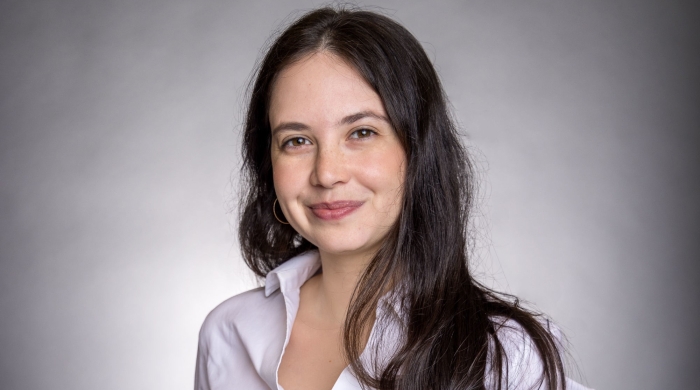 woman with a white shirt on gray backdrop 