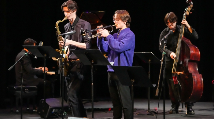 Four jazz players performing on stage