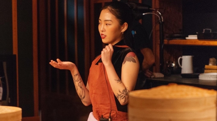 Zoey stands in a kitchen.