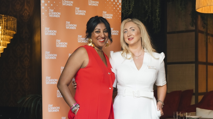 Shoba and Fran stand next to each other in front of a SW London Women banner