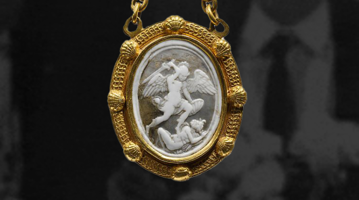 Graphic image of a gold pendant overlayed on top of a black and white image of a man