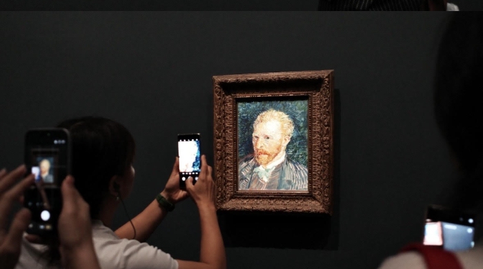 Two photos of museum goers taking digital photos of a portrait of Vincent Van Gogh.