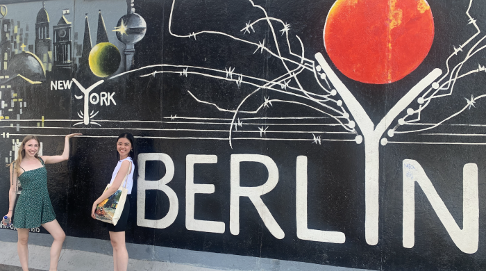 Two students standing in front of Berlin sign