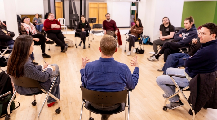 Instructors and students sitting in circle talking