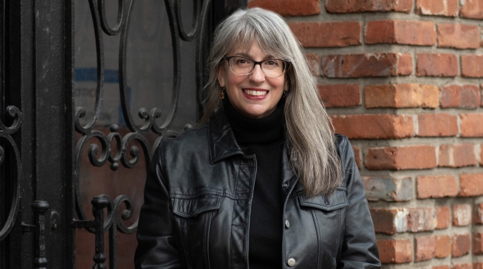 Headshot of Abby standing in all black clothes