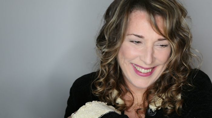 Singer and Songwriter Beth Neilsen Chapman headshot smiling and looking down