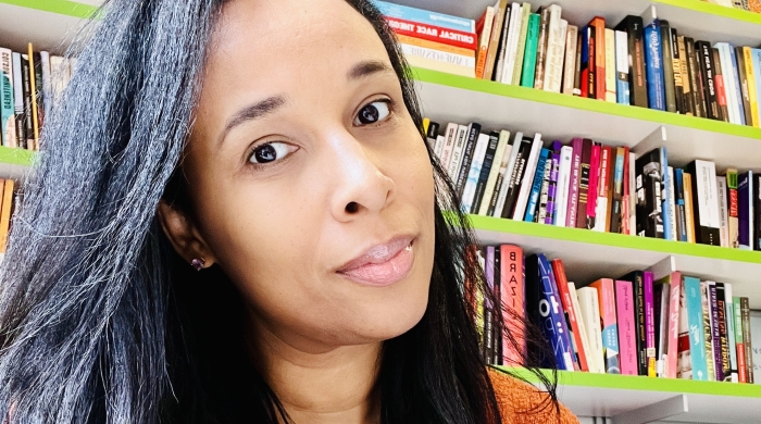 Dr. Honey Crawford sits in front of a bookshelf 