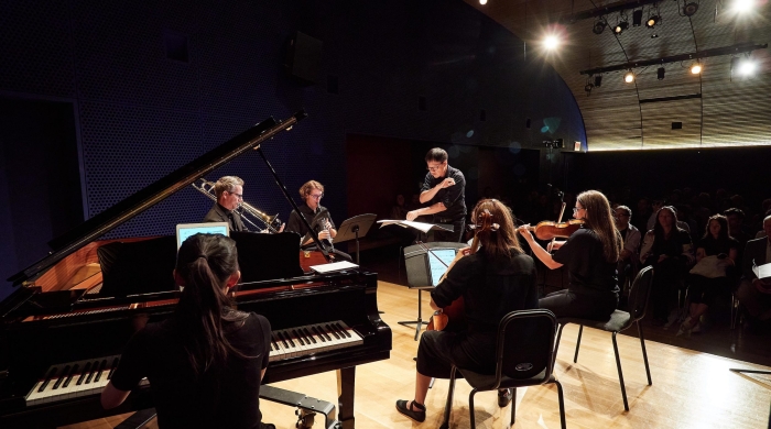 Photo of the Mise-En Ensemble performing in a small theatre