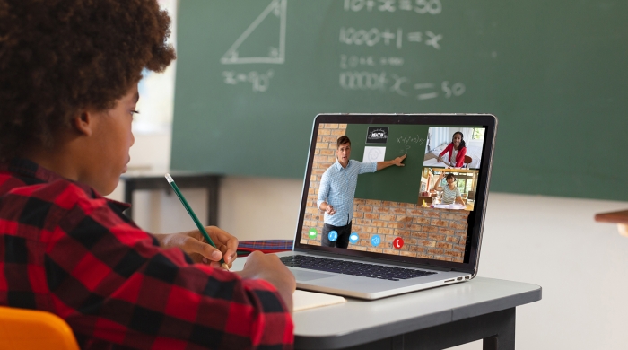Student in a math class in front of a computer getting online tutoring.