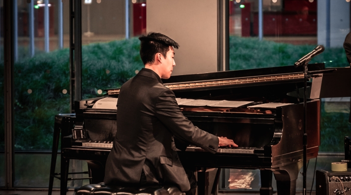 Lee plays piano