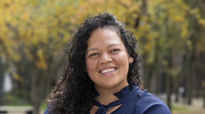 Professional Headshot of Sara-Lee, smiling with arms crossed comfortably in front