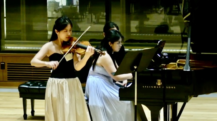 Violinist and pianist performing together in Paulson Center