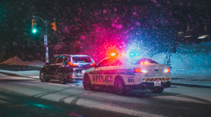 Police Car and a SUV parked on Roadside