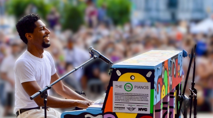 Jon Batiste plays at a piano