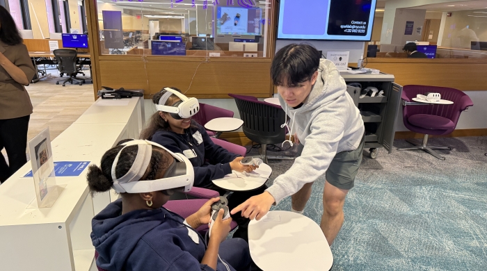 Middle school students wear virtual reality goggles as NYU Path's day of learning. 