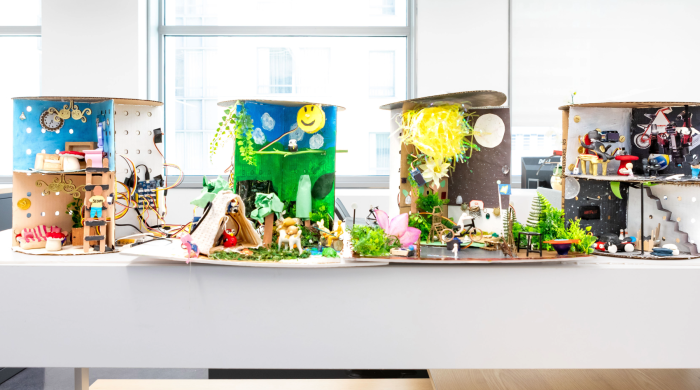 Four installation projects sit on a table