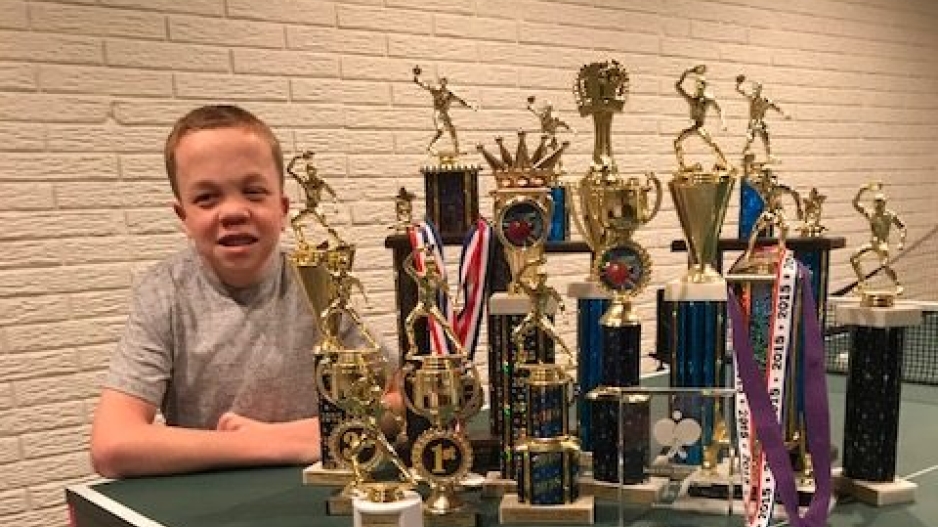 Andrew and his table tennis trophies.