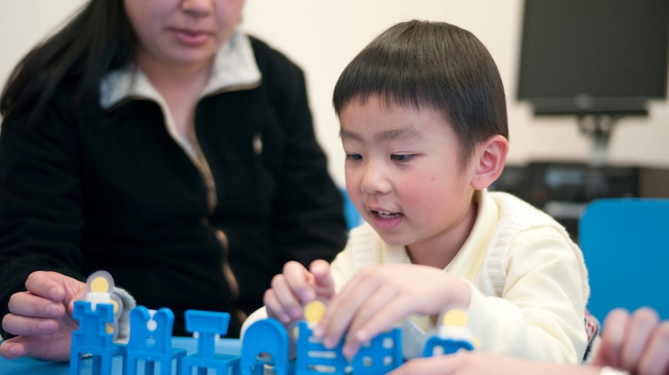 photo of a child playing with a counselor