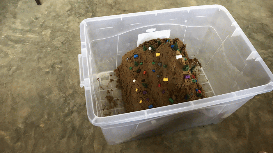 A replica of a mudslide created in a sandbox